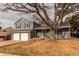 Two-story home with a two-car garage and a large tree in the front yard at 7163 S Xanthia St, Centennial, CO 80112