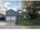 Charming two-story home featuring a two-car garage, a well-maintained lawn, and mature trees at 7163 S Xanthia St, Centennial, CO 80112