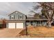 Charming two-story home with a two-car garage, inviting front porch, and landscaped yard at 7163 S Xanthia St, Centennial, CO 80112