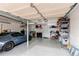 Spacious garage with epoxy flooring, storage shelves, a car, and a work bench at 7163 S Xanthia St, Centennial, CO 80112