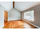 Bright living room featuring hardwood floors, a vaulted ceiling, and a large window at 7163 S Xanthia St, Centennial, CO 80112