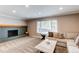 Bright living room with a brick fireplace, neutral carpet, and a large window with natural light at 7163 S Xanthia St, Centennial, CO 80112