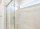 Clean shower with sliding glass door and neutral tile at 8905 Rifle St, Commerce City, CO 80022