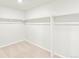 Large walk-in closet with double rods and neutral carpeting at 8905 Rifle St, Commerce City, CO 80022