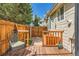 Cozy backyard with wooden deck, privacy fence, and chair at 8843 W Phillips Dr, Littleton, CO 80128