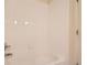 Bathroom with white tiled tub and shower combination at 8843 W Phillips Dr, Littleton, CO 80128