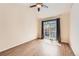 Bedroom featuring sliding glass doors to a patio with wood-look floors and a ceiling fan at 8843 W Phillips Dr, Littleton, CO 80128