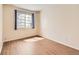 Bright bedroom with wood-look flooring and window at 8843 W Phillips Dr, Littleton, CO 80128