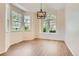 Dining room featuring large windows and a modern chandelier at 8843 W Phillips Dr, Littleton, CO 80128