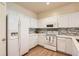 Bright kitchen featuring white cabinets, stainless steel appliances and wood look flooring at 8843 W Phillips Dr, Littleton, CO 80128