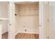 Laundry room with wood-look floors and shelf storage at 8843 W Phillips Dr, Littleton, CO 80128