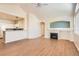 Bright living room featuring a fireplace, ceiling fan, and wood-look floors at 8843 W Phillips Dr, Littleton, CO 80128