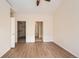 Main bedroom with wood-look floors, a closet, and an en suite bathroom at 8843 W Phillips Dr, Littleton, CO 80128