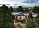 Overhead view of the home showing mature trees and landscaped front and back yards at 3823 Castle Butte, Castle Rock, CO 80109