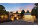 Modern home exterior featuring a spacious driveway and attached two-car garage with transparent doors at 3823 Castle Butte, Castle Rock, CO 80109