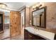 Bathroom showcasing tile floor, modern vanity with gold hardware, and a view into other rooms at 1415 S Jasmine Way, Denver, CO 80224