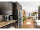 Contemporary kitchen featuring stainless steel appliances, dark cabinets, granite countertops, and hardwood floors at 1415 S Jasmine Way, Denver, CO 80224