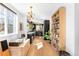 Well-lit modern kitchen with sleek black cabinets, stainless steel appliances, hardwood floors, and ample counter space at 1415 S Jasmine Way, Denver, CO 80224