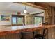 Entertaining bar area with seating, mountain views, and rustic wooden beams at 6241 Kilimanjaro Dr, Evergreen, CO 80439