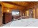 Cozy log bedroom boasts a rustic charm with wooden walls, mountain view, and cottage decor at 6241 Kilimanjaro Dr, Evergreen, CO 80439