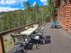 Outdoor seating area with views, table, and chairs, ideal for enjoying the serene surroundings at 6241 Kilimanjaro Dr, Evergreen, CO 80439