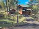 A beautiful log home with a well manicured lawn and driveway located in a tranquil neighborhood at 6241 Kilimanjaro Dr, Evergreen, CO 80439
