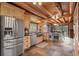 Spacious kitchen featuring stainless steel appliances, wooden cabinets, and an eat-in island at 6241 Kilimanjaro Dr, Evergreen, CO 80439