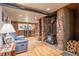 Comfortable living room featuring wood floors, a stone fireplace, and a bar area for relaxation at 6241 Kilimanjaro Dr, Evergreen, CO 80439
