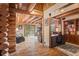 Inviting living space with rustic charm, featuring log walls, wood floors, and an open floor plan at 6241 Kilimanjaro Dr, Evergreen, CO 80439