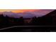 Serene pool reflecting a colorful sunset over the mountains at 6241 Kilimanjaro Dr, Evergreen, CO 80439