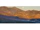 Beautiful mountain view at sunset with warm tones and a full moon, offering a picturesque setting at 6241 Kilimanjaro Dr, Evergreen, CO 80439
