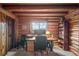 Charming office featuring log walls, a wooden desk, and a mountain view at 6241 Kilimanjaro Dr, Evergreen, CO 80439