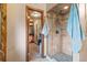 Stylish walk-in shower offers custom tile work and a convenient adjoining walk-in closet at 6241 Kilimanjaro Dr, Evergreen, CO 80439