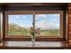 Charming window displays a mountain view, with fresh flowers adding a touch of nature at 6241 Kilimanjaro Dr, Evergreen, CO 80439
