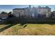 View of townhomes from the backyard featuring lawn, fences, and blue sky at 1732 S Blackhawk Way # D, Aurora, CO 80012