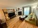 Comfortable living room with hardwood floors, fireplace, and sliding doors to bring in natural light at 1732 S Blackhawk Way # D, Aurora, CO 80012
