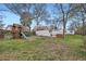 Spacious backyard features a playhouse, swing set, hot tub, and mature trees at 2481 Garrison St, Lakewood, CO 80215