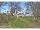 Expansive backyard features mature trees, green grass, and a detached garage at 2481 Garrison St, Lakewood, CO 80215