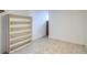 Unfinished basement featuring a wall of shelves, offering storage solutions at 2481 Garrison St, Lakewood, CO 80215