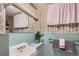 Vintage-style bathroom featuring floral wallpaper and light blue tile at 2481 Garrison St, Lakewood, CO 80215
