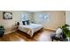Bright bedroom featuring hardwood floors, two windows, and tasteful decor at 2481 Garrison St, Lakewood, CO 80215