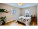 Bright bedroom with hardwood floors and patterned bedding, creating a cozy atmosphere at 2481 Garrison St, Lakewood, CO 80215