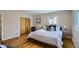 Cozy bedroom with wood floors, closet, and a decorative flower print on the wall at 2481 Garrison St, Lakewood, CO 80215