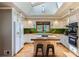 Bright kitchen with stainless appliances, skylight, modern finishes, and an island with seating at 2481 Garrison St, Lakewood, CO 80215