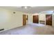 Open living room with carpet and natural light, adjacent to a doorway and closet at 2481 Garrison St, Lakewood, CO 80215