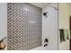 Bathroom shower with decorative geometric tiling and white subway tile at 2481 Garrison St, Lakewood, CO 80215