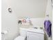 Cozy bathroom featuring a sink, toilet, and simple shelf for storage at 2595 S Irving St, Denver, CO 80219