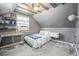 Unique attic bedroom with sloped ceilings, gray carpet, and space-themed decorations at 2595 S Irving St, Denver, CO 80219