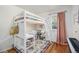 Cozy bedroom with lofted bed, desk space, colorful rug, and natural light at 2595 S Irving St, Denver, CO 80219