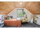 Charming bedroom with wood ceiling, and built-in desk, featuring a large window at 2595 S Irving St, Denver, CO 80219